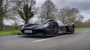 Aston Martin Valkyrie hypercar speeding through Silverstone, showcasing F1-inspired aerodynamics and record-breaking performance.