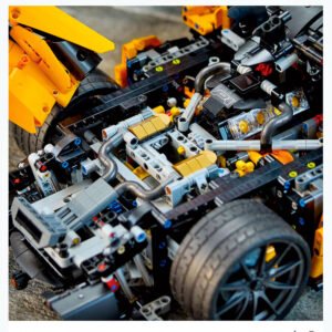 LEGO Technic McLaren P1 in bright orange, featuring intricate mechanics, butterfly doors, and a functional V8 engine