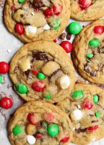 Alt Text: A festive plate of Chocolate Chip M&M Christmas Cookies featuring red and green M&Ms, surrounded by holiday decorations