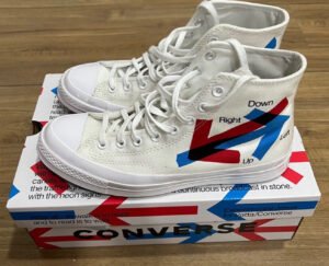 A pair of Patta x Converse Chuck Taylor sneakers featuring bold branding, earthy tones, and premium materials in a modern design