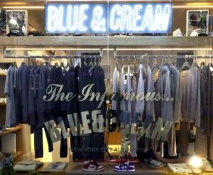 The Blue & Cream Clothing boutique in NYC, showcasing curated collections of luxury and streetwear in a sleek exterior setting