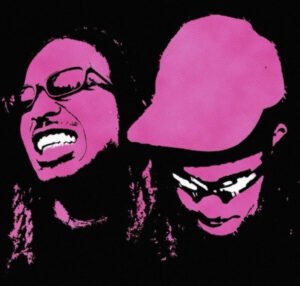 DDG and PlaqueboyMax performing ‘Pink Dreads’ with neon visuals, pink dreads glowing under futuristic lights