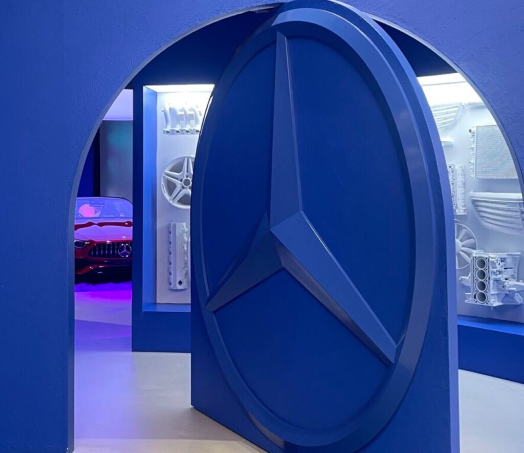 A luxurious Mercedes-Benz showroom with customers enjoying a stylish lounge, exploring cars in a relaxed atmosphere