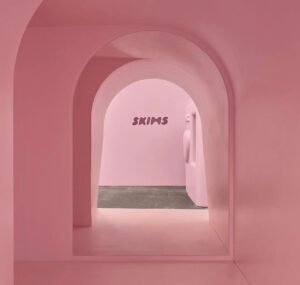 A vibrant pink Skims Valentine’s Day pop-up featuring heart-shaped decor, showcasing an immersive shopping experience