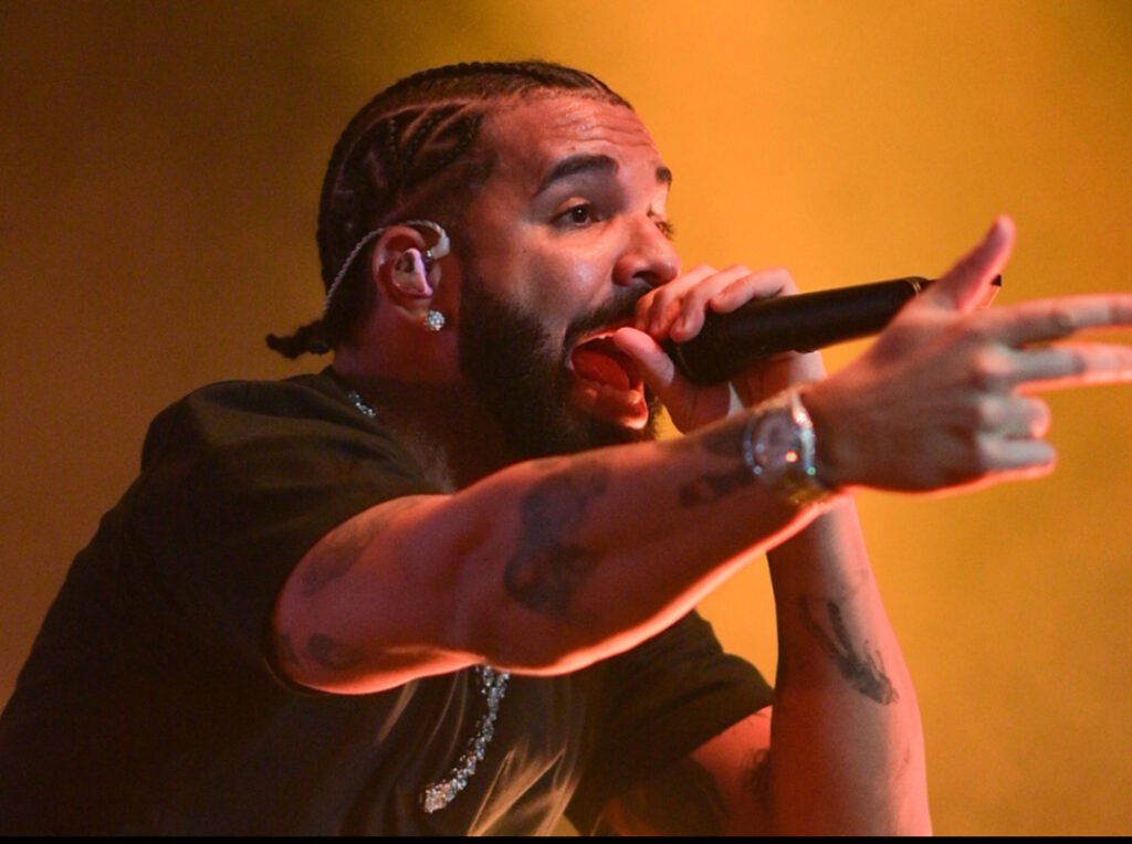 Drake performing on stage, hinting at his upcoming introspective solo album release