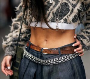 Trendy individuals showcasing bold Fashion Week street style looks, featuring oversized blazers, statement accessories, and unique footwear