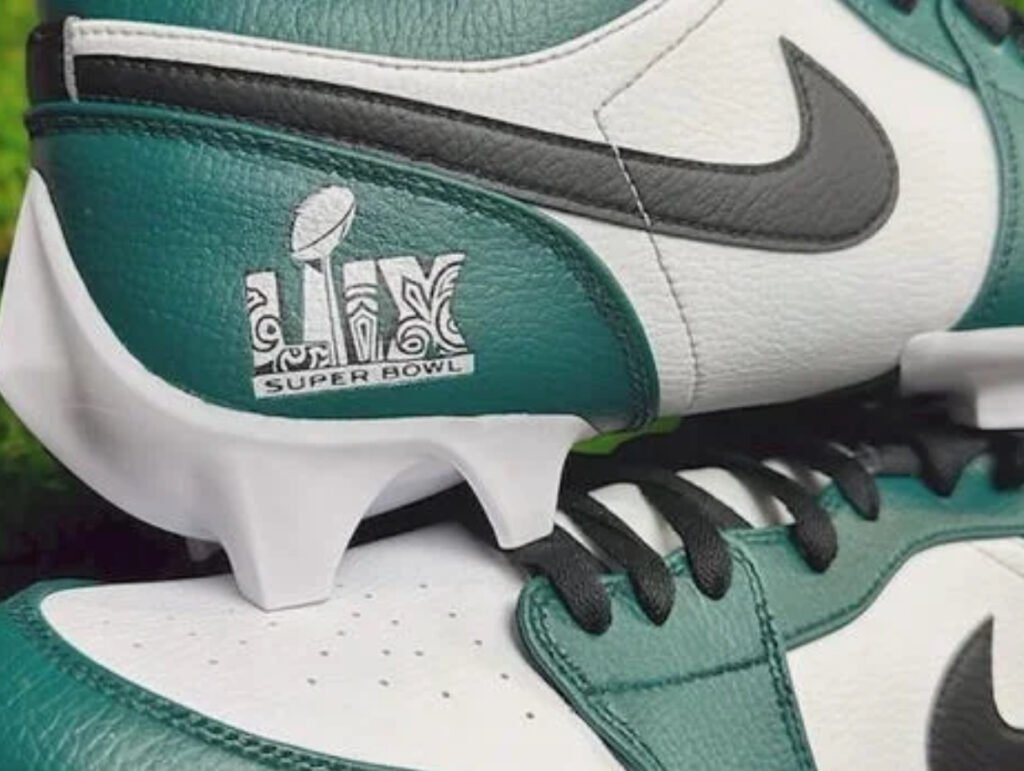Close-up of Cooper DeJean’s custom Super Bowl LIX cleats, designed by NXT LVL Customs, featuring unique artwork and team colors