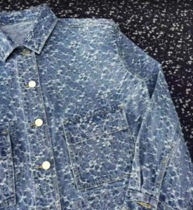 A skilled worker crafting premium denim jeans in a sustainable apparel factory, showcasing attention to detail and quality