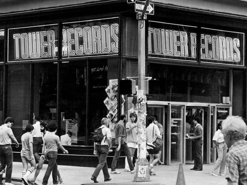 East 4th Street and Broadway intersection in New York City during the 1990s, showcasing the clash between gritty underground culture and gentrification