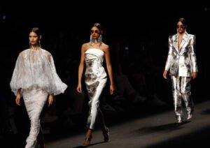 Backstage at Mercedes-Benz Fashion Week Madrid FW25, featuring designers, models, makeup artists, and final runway preparations