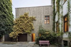 “Renovated war-damaged coach house in Berlin by J. Mayer H. Architects, showcasing historic restoration and modern design.”