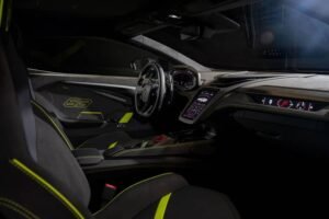 Ducati Panigale V4 Lamborghini Speciale Clienti motorcycle in lime green with carbon fiber detailing, displayed in showroom