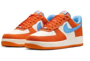 Nike Air Force 1 Low sneakers in Safety Orange and Light Blue colorway, displayed against a neutral background