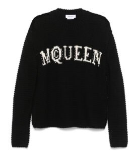 Alexander McQueen logo-intarsia sweater in black with white logo across the chest, laid flat on a minimalist surface