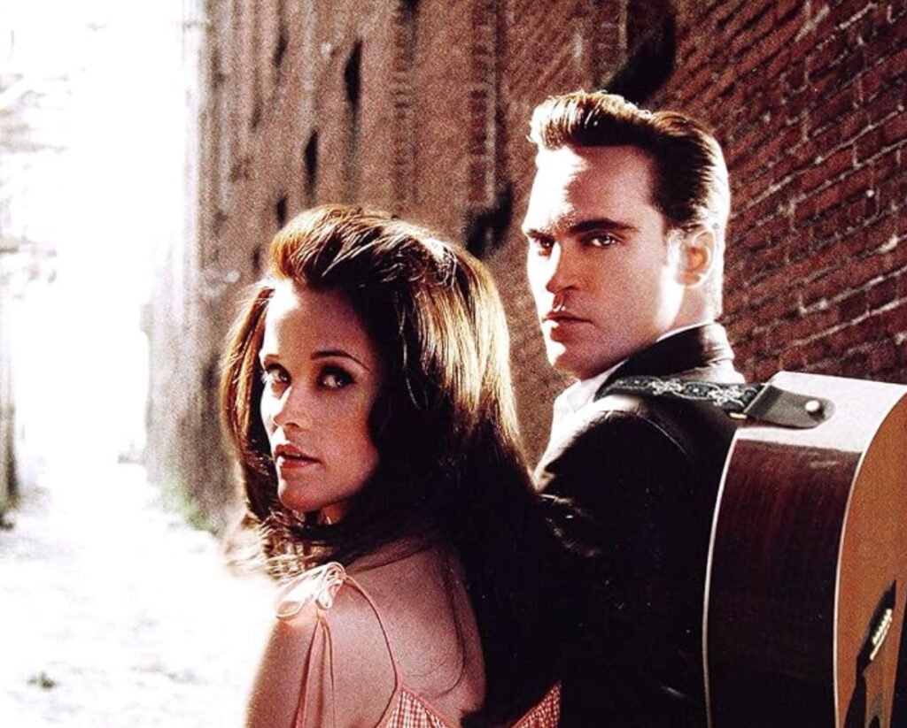 Joaquin Phoenix as Johnny Cash performing in Walk the Line (2005), with Reese Witherspoon as June Carter