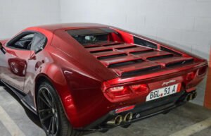 ARES Panther ProgettoUno driving on an alpine road at sunset