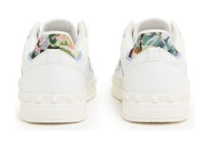 Valentino Garavani Freedot low shoes in bone white leather with tonal rubber sole and minimal branding, side profile view