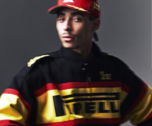 Rhude x Pirelli racing jacket with motorsport patches on asphalt backdrop