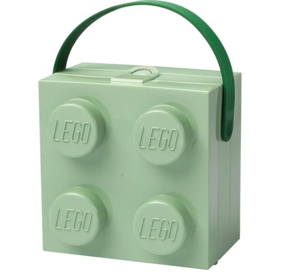 Room Copenhagen LEGO Box with Handle in soft sand green, featuring a studded lid, silicone handle, and compact design