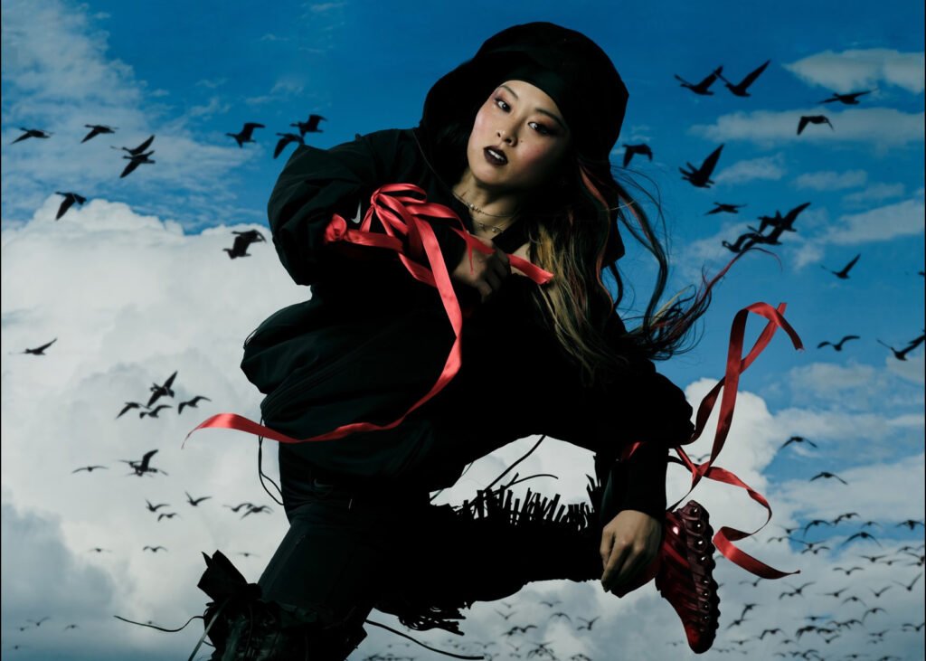 Sunny Choi mid-breakdance move, framed by Olympic lights, symbolizing strength and fluid motion