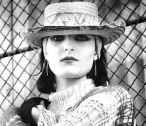 Siouxsie Sioux performing on stage with dramatic makeup and gothic style, iconic figure of post-punk and alternative music