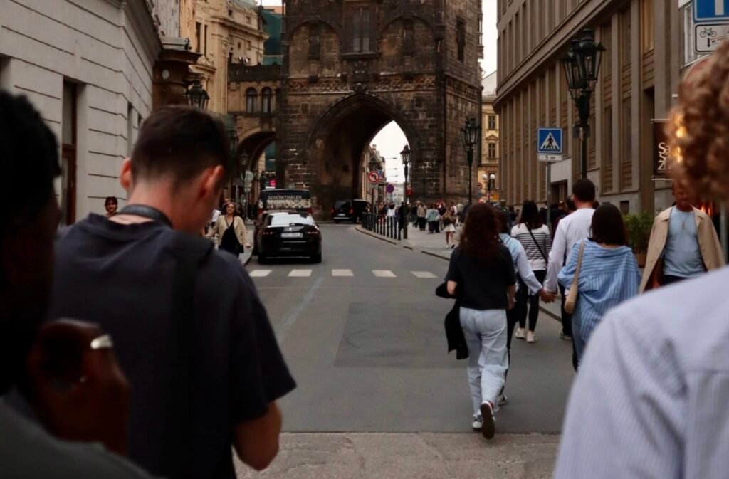 Group of friends walking through historic streets of Prague during a relaxed and reflective lads’ holiday experience
