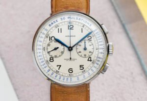 Close-up of a vintage Movado 95M chronograph with François Borgel case, featuring dual subdials and signature thumb-lever reset