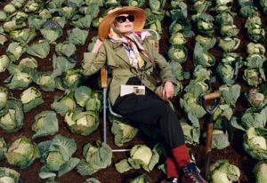 Models wear Burberry Highgrove capsule pieces in an English garden, showcasing nature-inspired British haute fashion