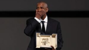 Denzel Washington on stage at the 2025 Cannes Film Festival accepting the Honorary Palme d’Or from Spike Lee