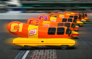 Wienermobiles racing at the Indianapolis Motor Speedway in the Wienie 500 hot dog competition