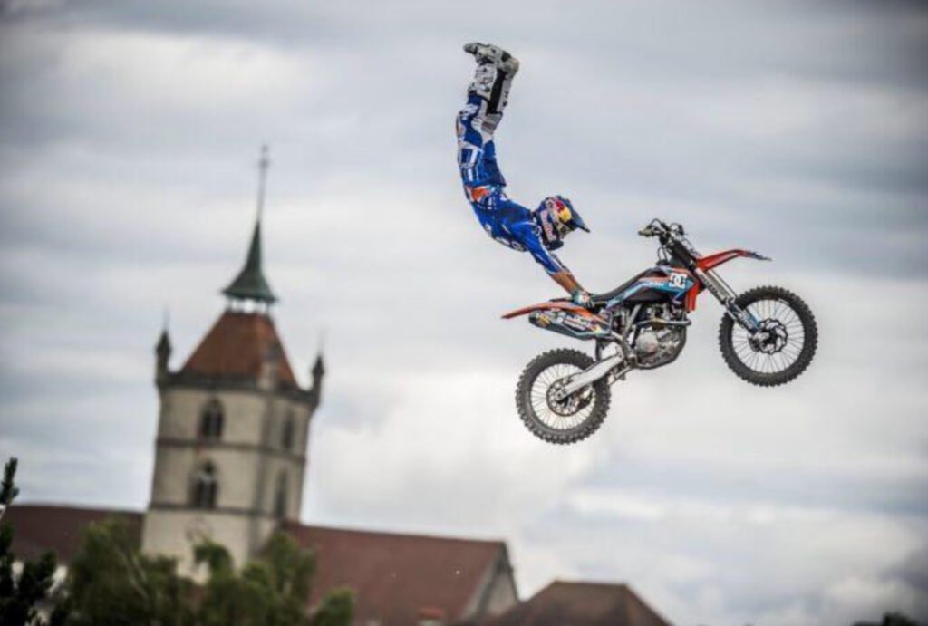 Robbie Maddison mid-air on a motocross bike, silhouetted against the sky
