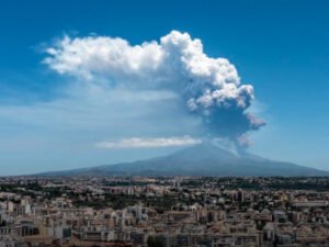 A plume of ash from Mount Etna rises into the morning sky on June 2, 2025, as tourists flee and flights are grounded