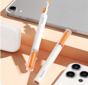 Baseus dual-head cleaning pen with orange bristle and precision tip beside earbuds and smartphones