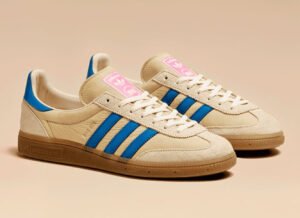adidas Originals x Sneakersnstuff SNS GT II sneaker in yellow suede with blue stripes and pink accents on a gum sole