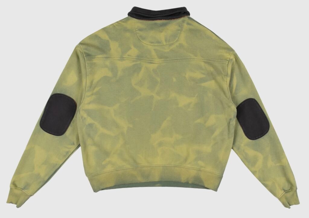 Back view of Dead Atlantic “Money Quarter Zip” sweatshirt in aged green enzyme-washed cotton. Features contrasting black elbow patches and collar, with a subtly marbled ozone-treated finish. Constructed from heavyweight French terry for a naturally aged California-made look.