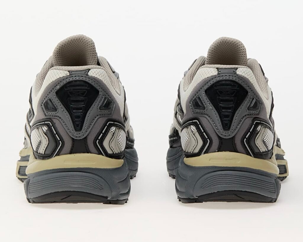Rear view of the Reebok Premier Road Ultra Tonal Grey sneakers, highlighting the layered heel construction in grey and black with reflective detailing, mesh ventilation panels, and cushioned midsoles for stability and support.