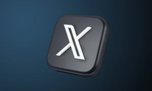3D-rendered logo of X (formerly Twitter) featuring a metallic white “X” on a dark gray square icon with rounded corners. The logo appears tilted against a gradient navy background, symbolizing the platform’s sleek rebranding and modernized digital identity.