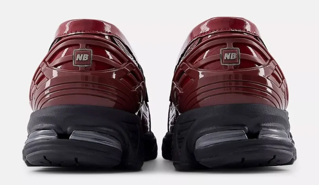 Rear view of the New Balance 1906 LCS Loafer “Red Croc,” showing the glossy croc-embossed heel panels with molded technical ridges, metallic NB heel badges, and the black cushioned midsole with visible N-ERGY pods