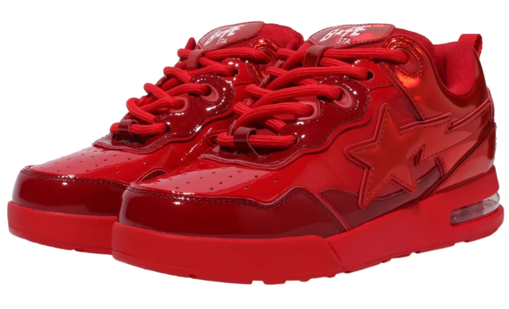 Side profile pair of the Bape US Limited Flip Sta Red sneaker with red overlays, white underlays, and the flipped Bape star logo, photographed on a seamless white backdrop