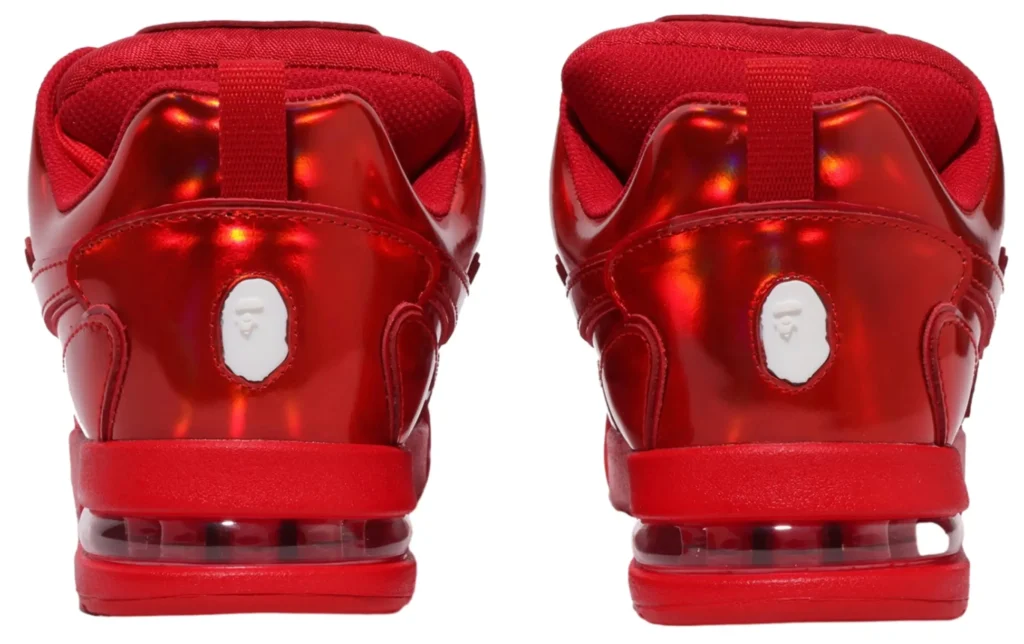 rear view of the Bape US Limited Flip Sta Red sneaker showing the symmetrical layout of the white leather toe box, red lace panels, and perforated vamp. The sneaker’s tongue tag with A Bathing Ape branding is centered in the frame, while the red overlays