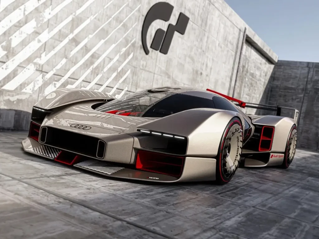 Front three-quarter view of the Audi 20quattro Vision GT concept car, featuring a low-slung aerodynamic body in metallic silver with red accents, futuristic wheel design, and prominent front lighting signature, displayed against a concrete backdrop with the Gran Turismo logo on the wall.
