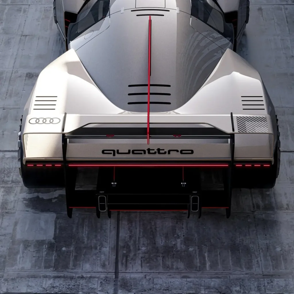 Rear view of the Audi 20quattro Vision GT concept car highlighting the bold “quattro” branding across the rear wing, illuminated Audi rings, intricate aerodynamic fins, and red accent lighting that emphasizes its futuristic race-ready design on a concrete surface.