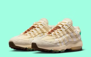 Side view of the Nike Air Max 95 Golf in a light cream and white colorway, featuring the model’s signature wavy layered upper, visible Air cushioning in the sole, and a golf-specific traction outsole, photographed on a white background