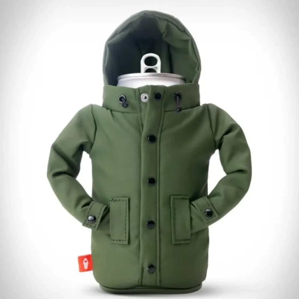 A beverage can wrapped in a Puffin Drinkware holder styled like an olive-green winter parka, featuring a hood, black snap buttons, stitched front pockets, wrist cuffs, and a structured insulated design that mimics cold-weather outerwear