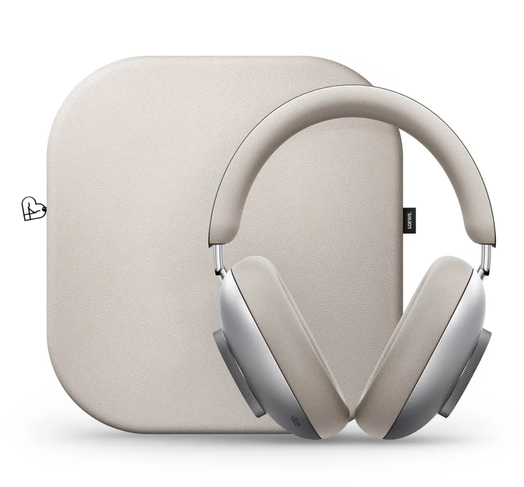 Loewe Leo over-ear headphones in brushed silver with soft beige ear pads, positioned in front of a matching beige carrying case, shown on a white background with a minimalist, premium aesthetic