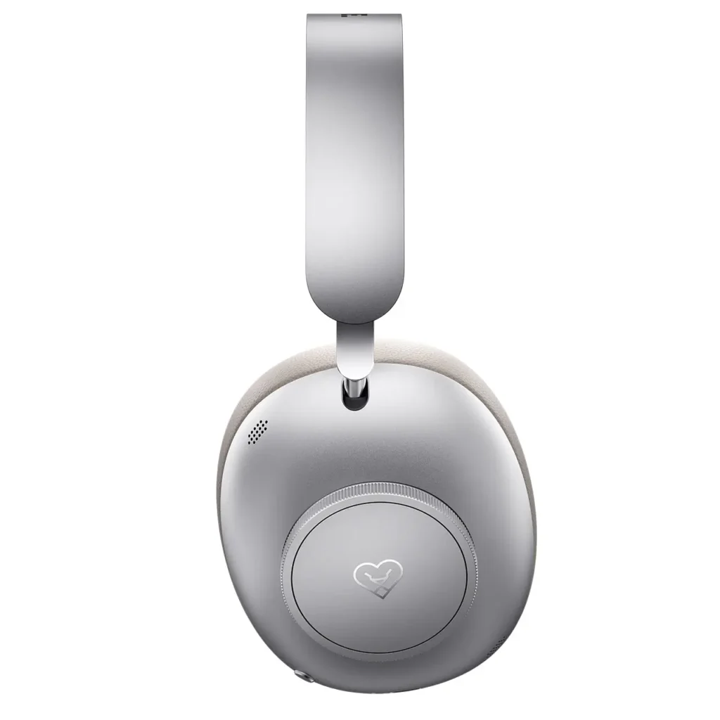 Side view of Loewe Leo over-ear headphones showing brushed silver aluminum ear cup with subtle logo detailing and softly padded beige headband, isolated on a white background