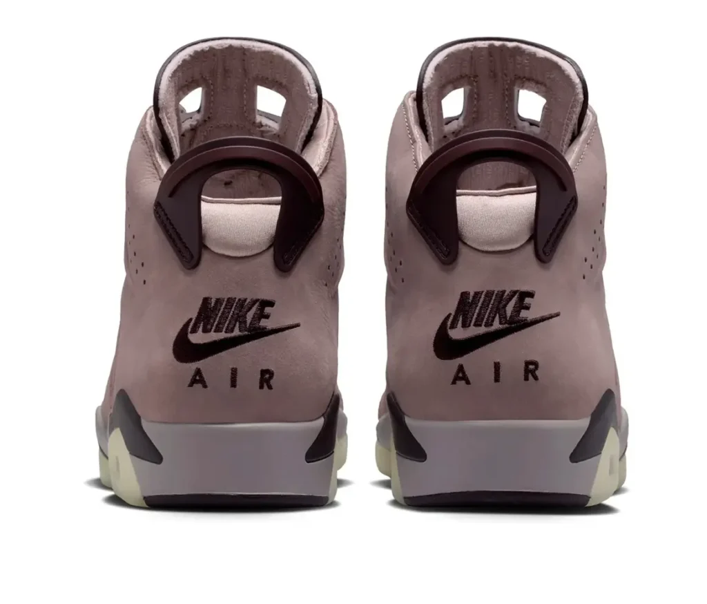 Rear view of the Air Jordan 6 × A Ma Maniére “Smokey Mauve,” highlighting the soft mauve suede heel panels, dark plum pull tabs, and bold embroidered “Nike Air” branding above the midsole