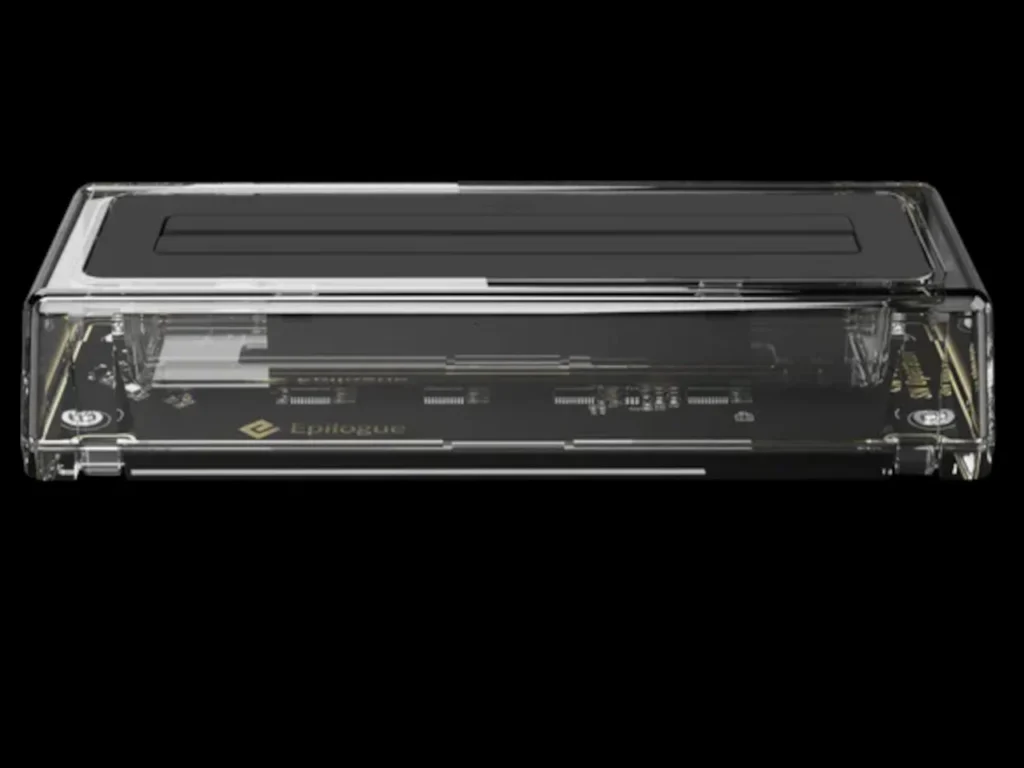 Transparent Epilogue SN Operator cartridge dock viewed from the side, showcasing its clear acrylic casing, internal circuit board, and minimalist rectangular form against a black background