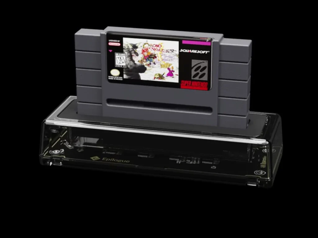Transparent Epilogue SN Operator USB-C cartridge dock holding a Super Nintendo Chrono Trigger cartridge, shown against a black background with visible internal circuitry beneath the inserted SNES game