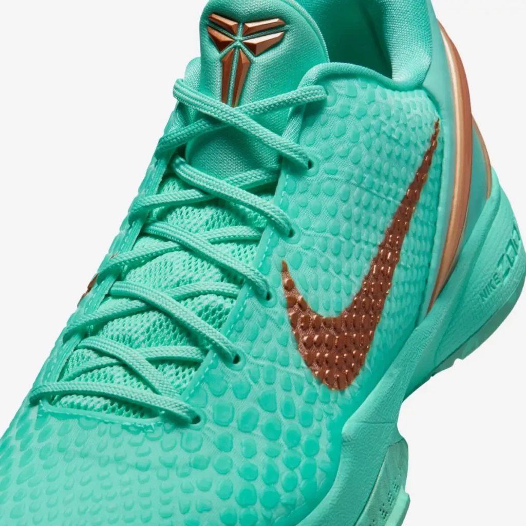 Close-up of the Nike Kobe 6 Protro “Statue of Liberty” showing textured green upper and bronze Swoosh